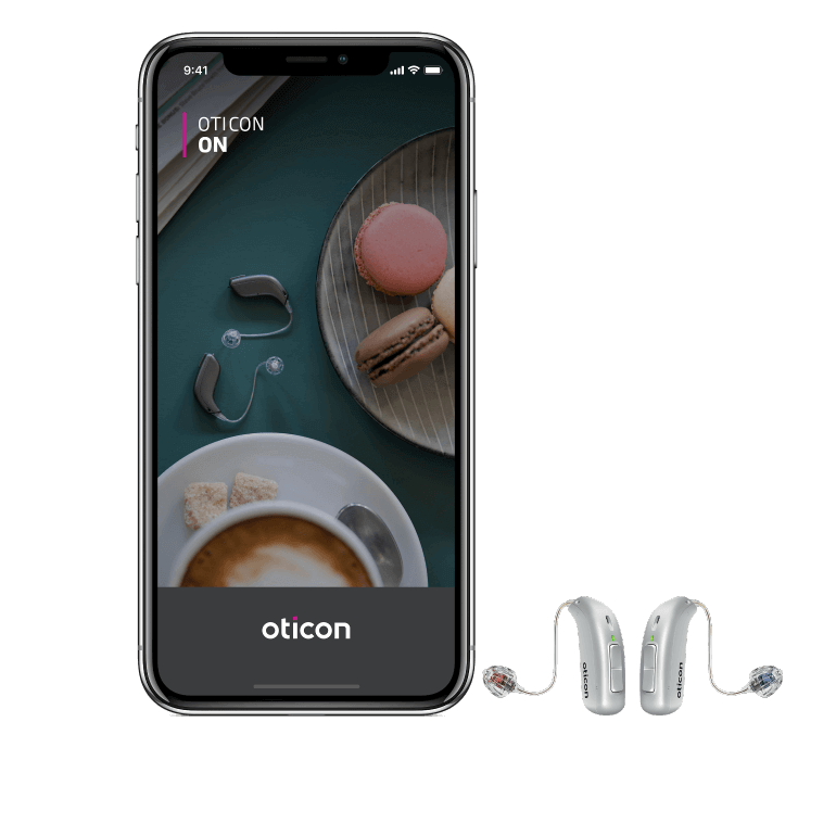 Oticon More hearing aids next to a smart phone