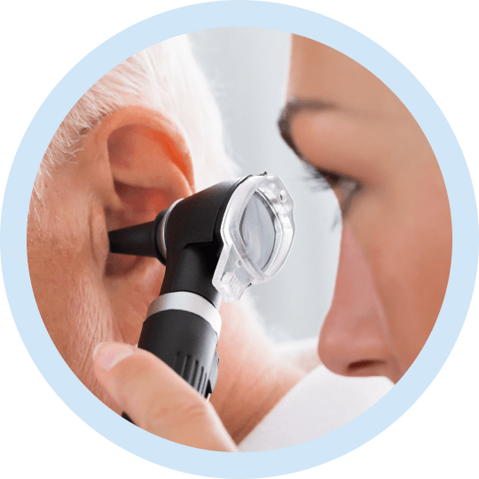 an audiologist, charlotte looking into an ear with an otoscope